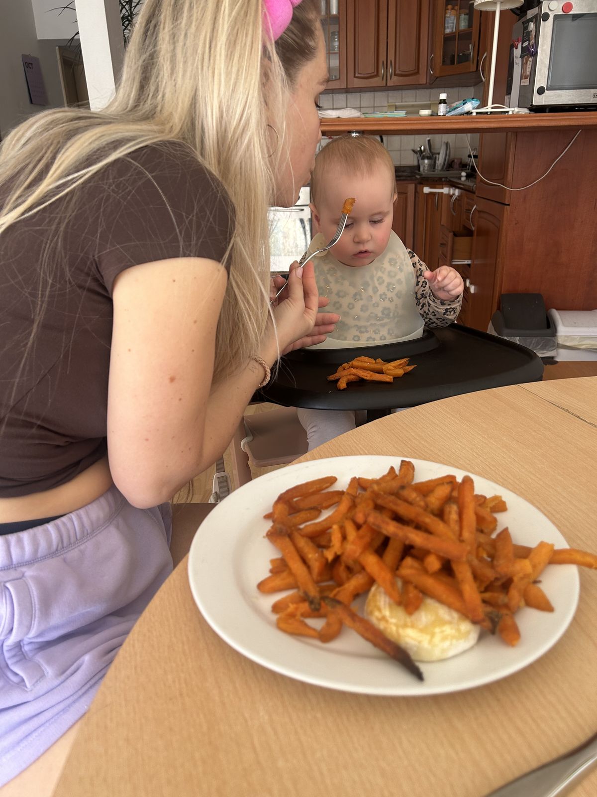 Betty blowing on Becky's food
