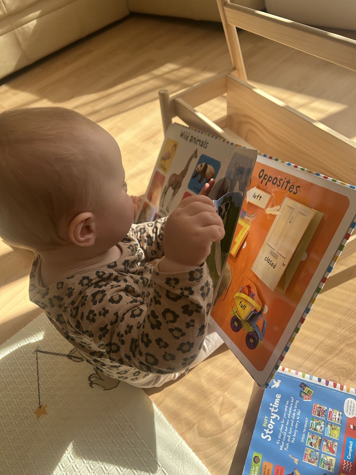 Becky lifting a flap in a book